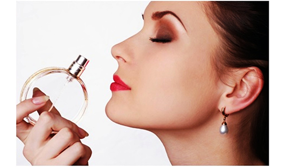 image of woman smelling perfume 1