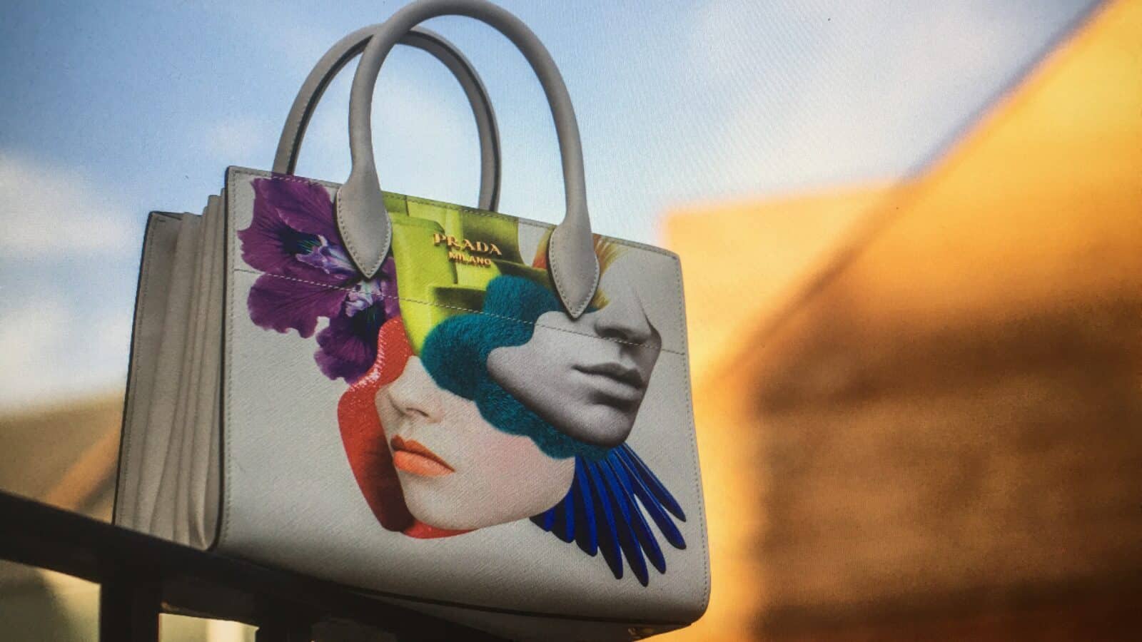 Stylish handbag featuring a vibrant face art illustration, perfect for fashion-forward accessories.