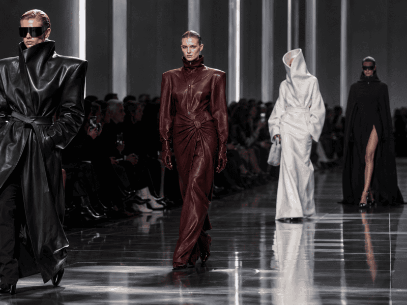 Elegant runway models showcase high-fashion leather and avant-garde designs at a modern fashion show.
