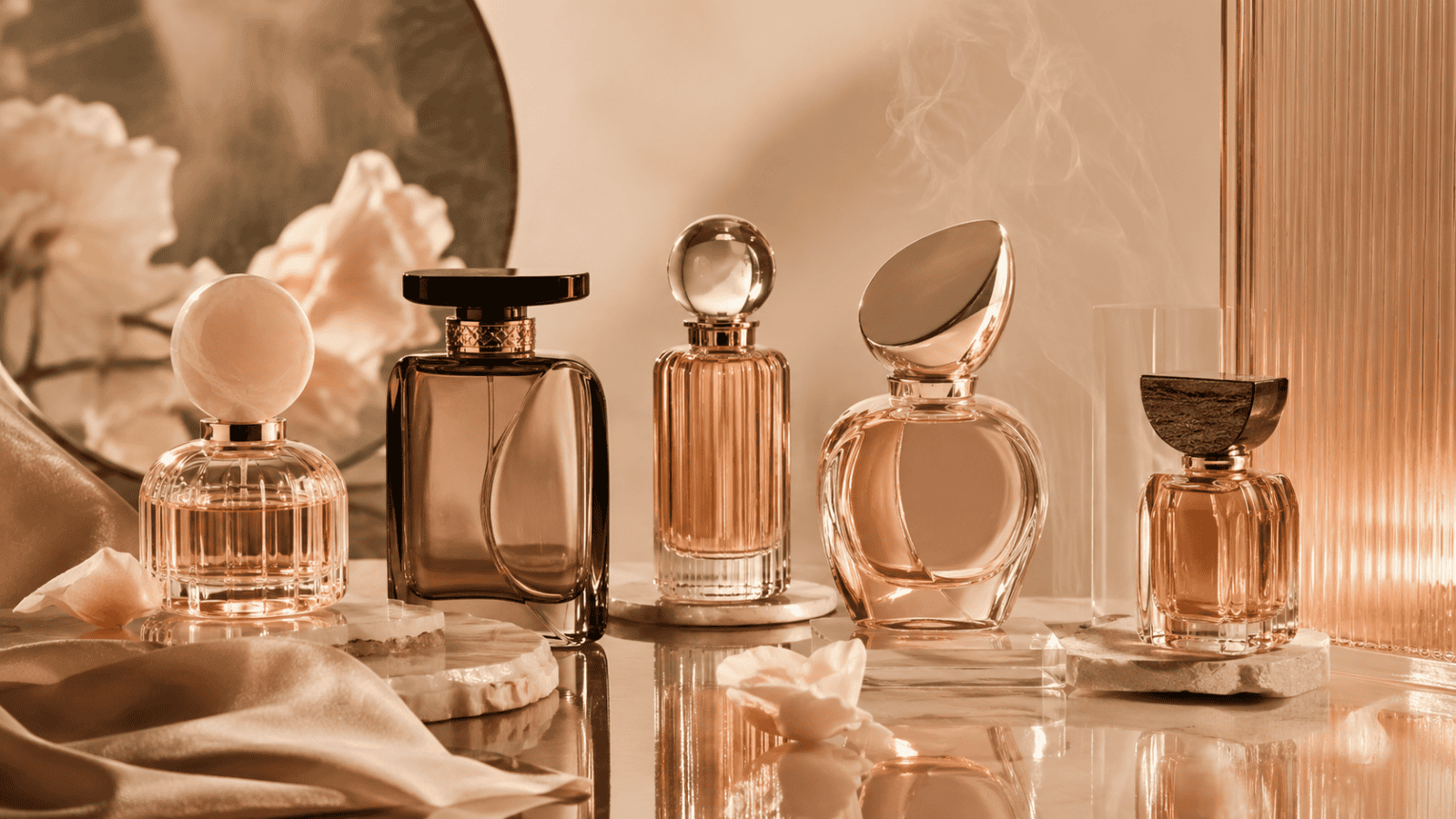 Elegant collection of luxury perfume bottles with warm lighting and soft background.